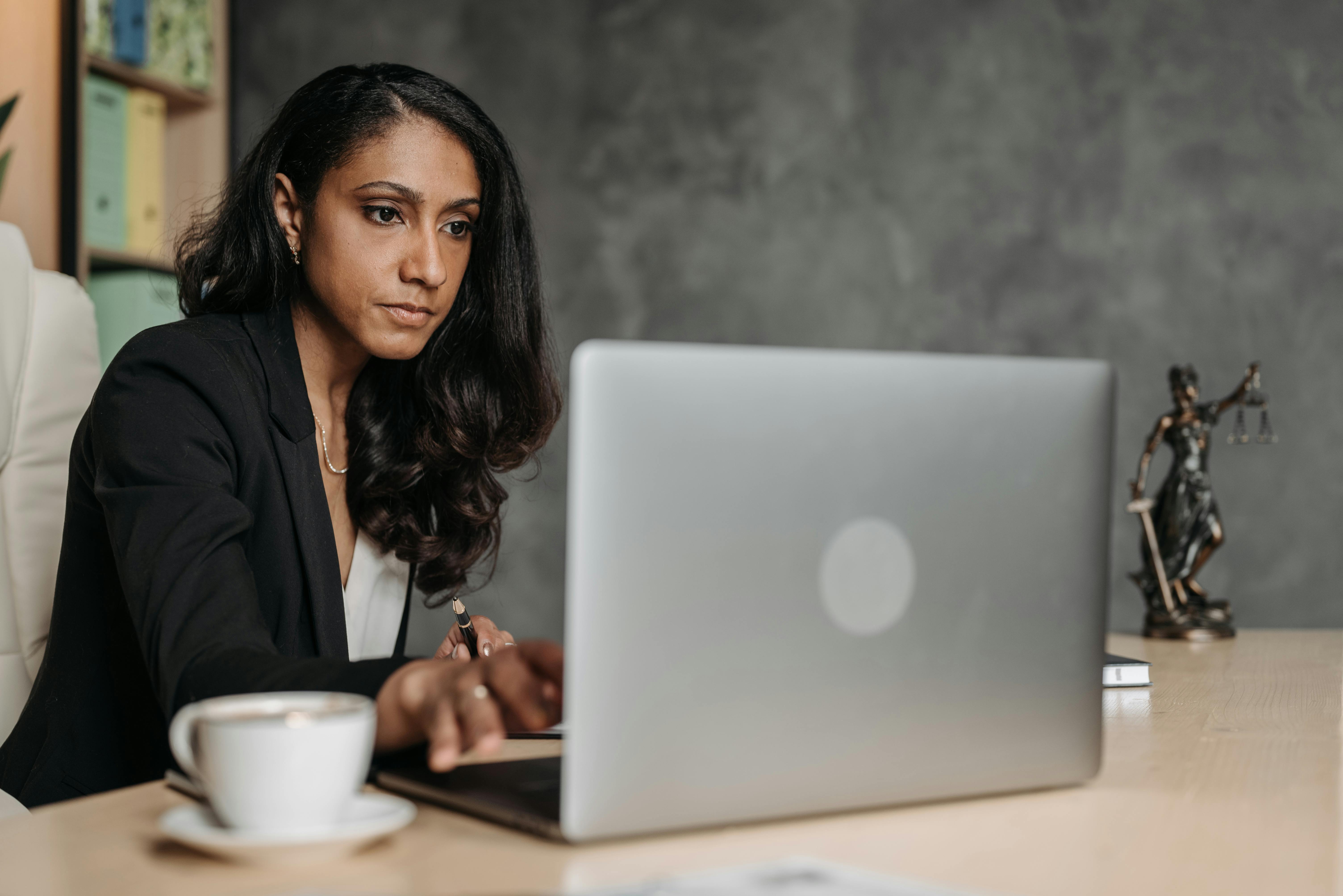 Woman researching cloud services for lawyers on her laptop in a law office.